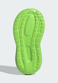 Green rubber sneaker outsole with textured grip patterns, featuring cloud-like cushioning and embossed 'CLOUDFOAM' branding.