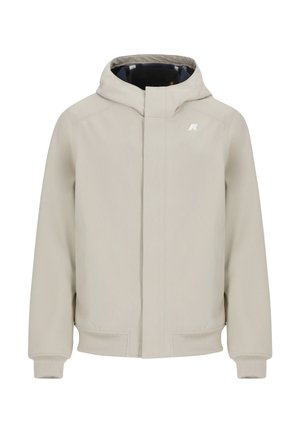 Giacca con cappuccio color beige chiaro con zip frontale, polsini a costine e dettaglio con logo. Presenta un tessuto liscio e un design minimalista.