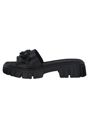 Black slide sandal with chunky ridged sole and wide strap featuring a large linked chain detail across the top.
