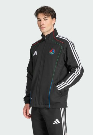 Black athletic jacket with a zip front, featuring white stripes on sleeves, colorful piping, and a logo on the chest. Polyester material.