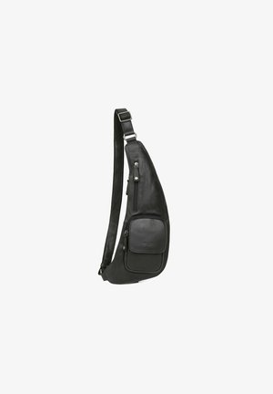 Black leather sling bag with a curved shape, adjustable strap, and front zippered pocket. Features smooth texture and minimal hardware.