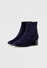 Pair of dark blue suede ankle boots with low block heels and rounded toes on a plain light background.
