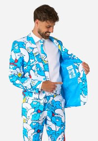 Blue suit with cartoon Smurf pattern, including a matching tie. Inner lining is light blue with a label. Fabric appears smooth, glossy.