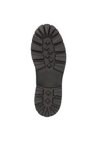 La suela de la bota de goma negra presenta surcos profundos, patrones hexagonales y un talón reforzado. Superficie lisa con el logo de la marca cerca del arco.
