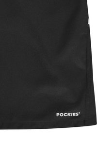 Fekete szövet sportnadrág texturált felülettel, fehér "POCKIES" logóval az alsó szegélyen és egyszerű, letisztult designnal.