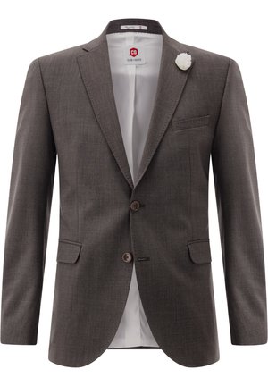Brown men's tailored blazer with two buttons, flap pockets, white lining, and white floral lapel pin on collar.