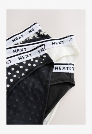 Lot de trois culottes pour femmes présentant un mélange de couleurs noir et blanc, des pois, un motif floral, et des tailles élastiques avec le logo de la marque.