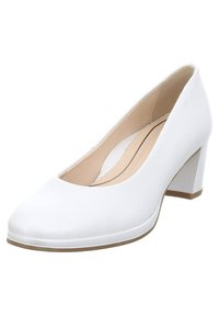 Chaussures à talons hauts blanches avec une texture lisse, un bout rond et un talon bloc de hauteur moyenne. L'intérieur présente un doublage beige et un minimalisme dans les détails.