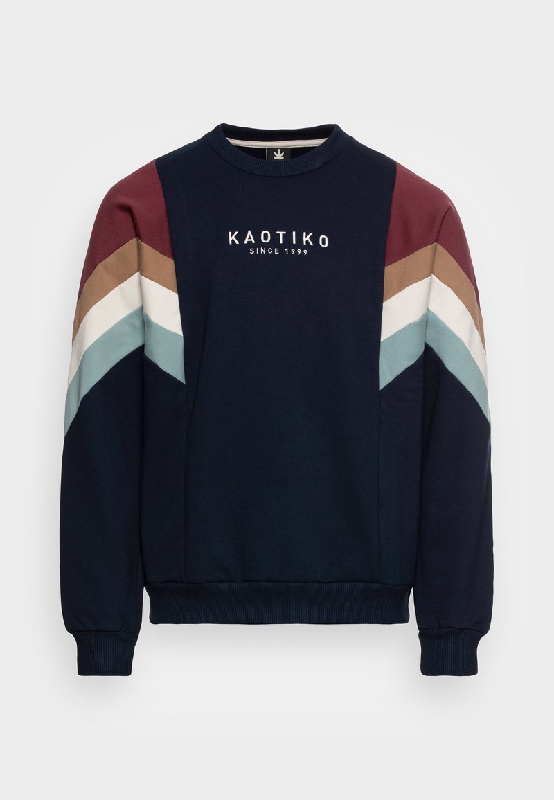 Sweat-shirt bleu marine avec poignets et ourlet côtelés, rayures chevron multicolores sur les manches, et texte "KAOTIKO SINCE 1999" sur la poitrine.