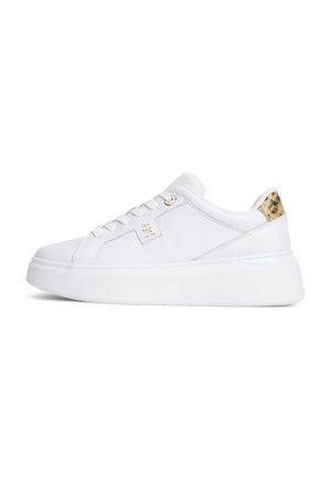 White low-top sneaker with lace-up front, thick sole, gold logo on side, and leopard print accent on heel collar.
