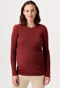 Sweter ciążowy w kolorze rdzawego brązu, z prążkowaną faktur�ą, długimi rękawami, okrągłym dekoltem oraz subtelnymi bufkami na ramionach.