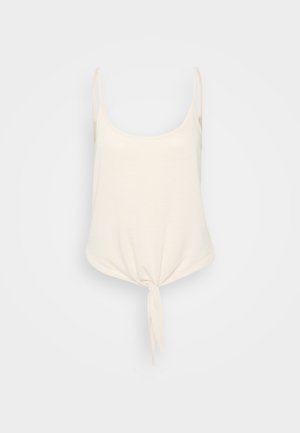 Kremasti top bez rukava s tankim trakama, okruglim izrezom i čvorom na struku, izrađen od mekog, laganog materijala.