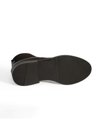 Zwarte rubberen schoen zool met een vlak, gestructureerd oppervlak en een lichte hak. Heeft een gladde rand en een versterkte achterkant.