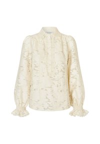 Blusa color crema con motivo floreale testurizzato, patta con bottoni e polsini arricciati. Dettaglio in pizzo al colletto e nella parte frontale. Maniche lunghe.