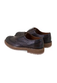 Brogues en cuir noir avec des détails perforés, bout arrondi et semelle en caoutchouc beige contrastante. Design classique à lacets. Surfaces lisses et texturées.