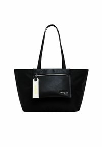Black tote bag with long handles, featuring a front zippered pocket and a white tag, made of a smooth, matte material. Minimalist design.
