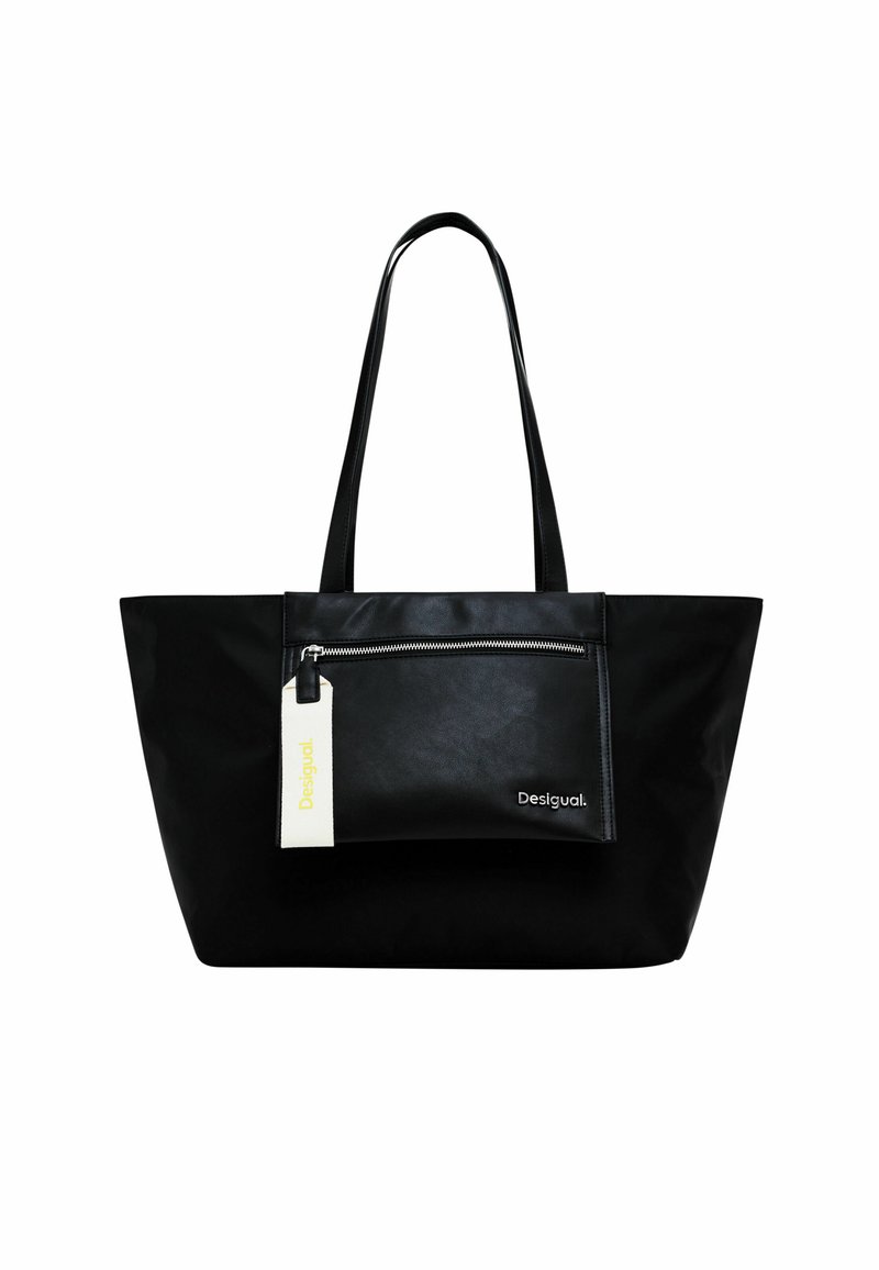 Black tote bag with long handles, featuring a front zippered pocket and a white tag, made of a smooth, matte material. Minimalist design.