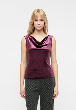 Purple satin sleeveless top with a draped cowl neckline, paired with textured dark patterned trousers. Smooth surface, fitted design.