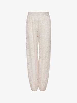 Pantalones holgados de encaje crema de cintura alta con cinturilla elástica y puños elásticos, con un patrón floral en todo el tejido.