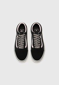 Black suede sneakers with pink accents and a woven black-and-white checkerboard lace design. Features a white rubber sole and padded collar.