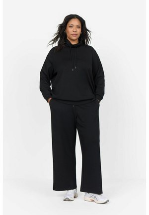 Black hoodie with drawstrings and relaxed fit, paired with black wide-leg pants. Casual styling, soft fabric, and minimal design.