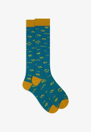 Teal knee-high socks with yellow fish patterns, yellow toes, heels, and cuffs, laid flat and overlapping on a white background.