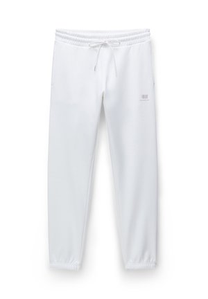 Witte sweatpants van zacht materiaal, met een elastische tailleband met trekkoord, geribbelde boorden en een klein logo aan de zijkant.