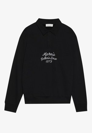Sweatshirt preto de pulôver com colarinho tipo polo, apresentando bordado branco que diz "Marais Gallerie Deux 1973" na parte da frente.