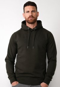 Felpa con cappuccio verde scuro, dotata di tasca frontale, cappuccio con cordino, polsini e bordo a costine. Tessuto liscio, design minimalista.