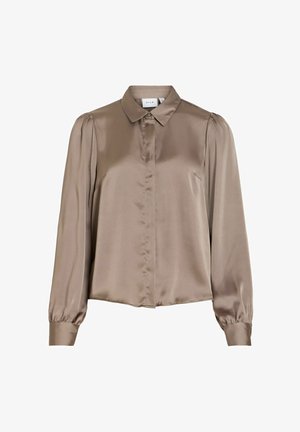 Brūna satīna krekls ar garām piedurknēm, apkakli, priekšā ar pogām un pūstām piedurknēm ar savilkumu. Gluda tekstūra ar klasisku piegriezumu.