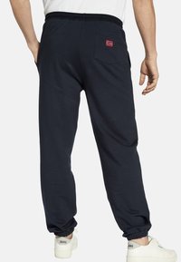 Jan Vanderstorm VEGAR - Tracksuit bottoms - dunkelblau