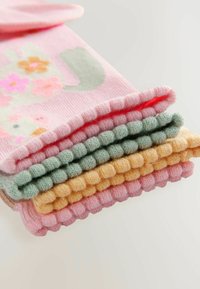 Colorful knit socks stacked, featuring shades of pink, green, and yellow with a ribbed texture and floral design on the top sock.