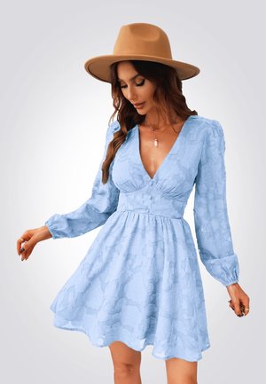 Un vestido azul claro con mangas largas abullonadas, escote en forma de V y un patrón floral texturizado. Falda acampanada y cintura ajustada, combinado con un sombrero color tostado.