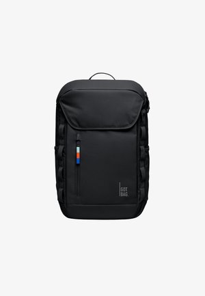 Zaino nero con un design strutturato, tasca frontale con zip, webbing laterale e un piccolo etichetta blu, bianca e rossa. Presenta una maniglia superiore per il trasporto.