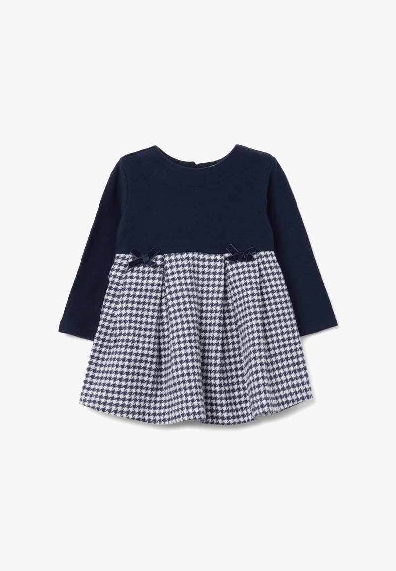 Abito lungo a maniche con vestibilità aderente in navy, con gonna svasata a motivo houndstooth, arricchita da due piccoli fiocchi scuri in vita.