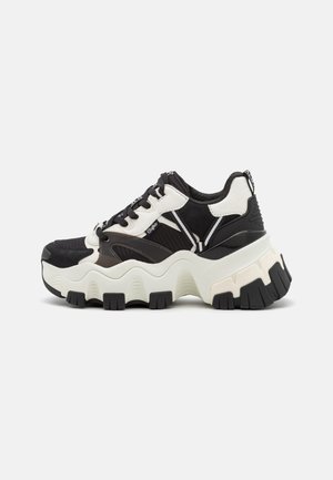 Sneakers chunky con una toma in rete nera, dettagli sintetici bianchi e una suola bianca spessa con battistrada in gomma nera.