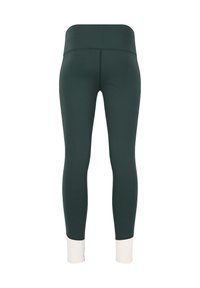 Leggings realizzati in un tessuto elastico di colore verde scuro con un'alta vita e polsini bianchi a contrasto alle caviglie. Texture liscia, design aderente.