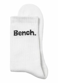 White crew socks made of cotton blend, featuring ribbed texture; "Bench." logo in black on the side for branding.