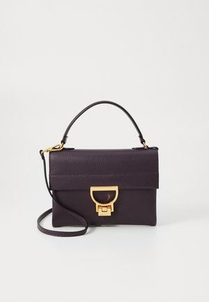 Purple leather handbag with a top handle and detachable shoulder strap. Features a gold-tone clasp and textured surface with a flat design.