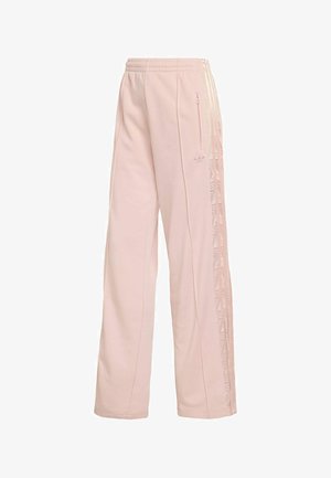Light pink sweatpants made of soft fabric, featuring a drawstring waistband, side zipper pockets, and diagonal striped accents along the sides.