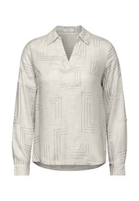 Blouse à manches longues gris clair avec un col en V, présentant des motifs abstraits de lignes sombres et des accents de boutons sur les manches. Tissu doux et tissé.
