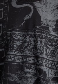 Black fabric featuring gray graphics, including a serpent, decorative motifs, and ancient figures with a Greek key pattern along the bottom.
