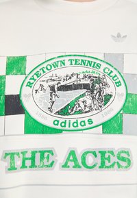 White cotton sweatshirt featuring a green and black tennis club graphic with checkered accents, and text reading "RYTETOWN TENNIS CLUB" and "THE ACES."