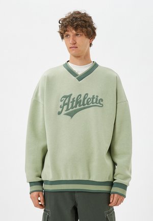 Hellegrüner Sweatshirt mit V-Ausschnitt und gerippten Bündchen. "Athletic" Logo in dunklerem Grün auf der Vorderseite. Verfügt über eine lässige Passform und strukturierter Stoff.