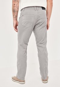 Light gray pants made of cotton blend fabric, featuring a straight-leg design, five pockets, and a textured surface.