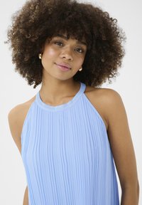 Light blue pleated halter top with a smooth texture; features a rounded neckline and an open back design.