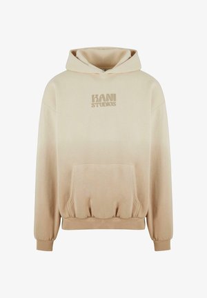 Hanorac oversize bej cu buzunar frontal, mâneci cu manșetă și logo-ul "KANI STUDIOS" imprimat ton pe piept. Textură de țesătură fină.