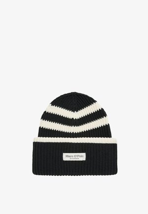 Knitted beanie in black with white chevron stripes. Features a ribbed texture and a white label stitched on the cuff.