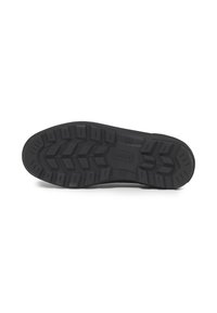 Semelle en caoutchouc noir avec un motif de semelle prononcé, conçu pour une traction optimale, avec un logo en relief au centre.