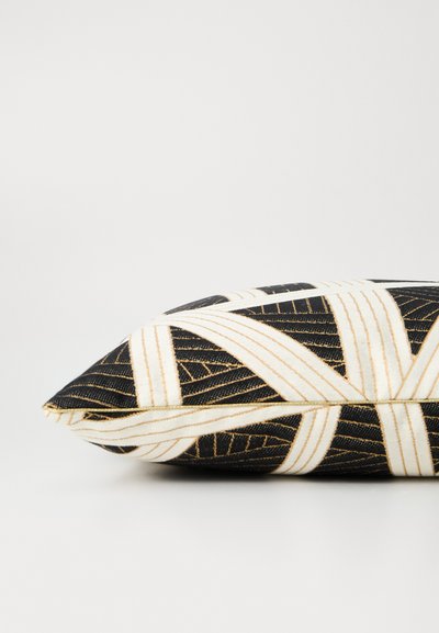 Black and white patterned pillow with gold accents, featuring a geometric design and a triangular shape. Soft fabric texture.